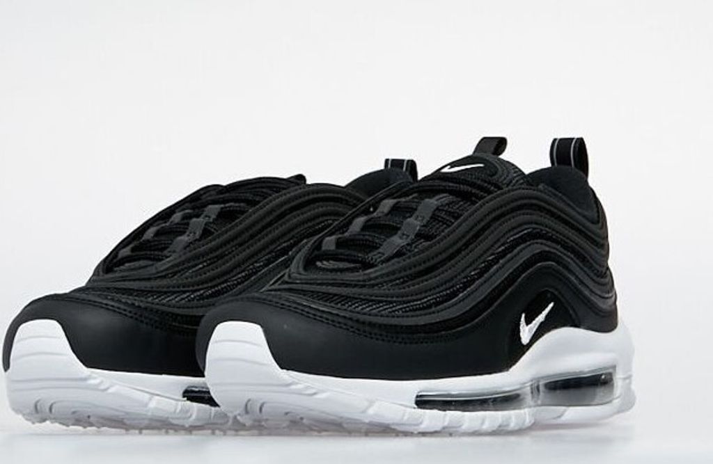 A pair of black and white Nike Air Max 97 sneakers.