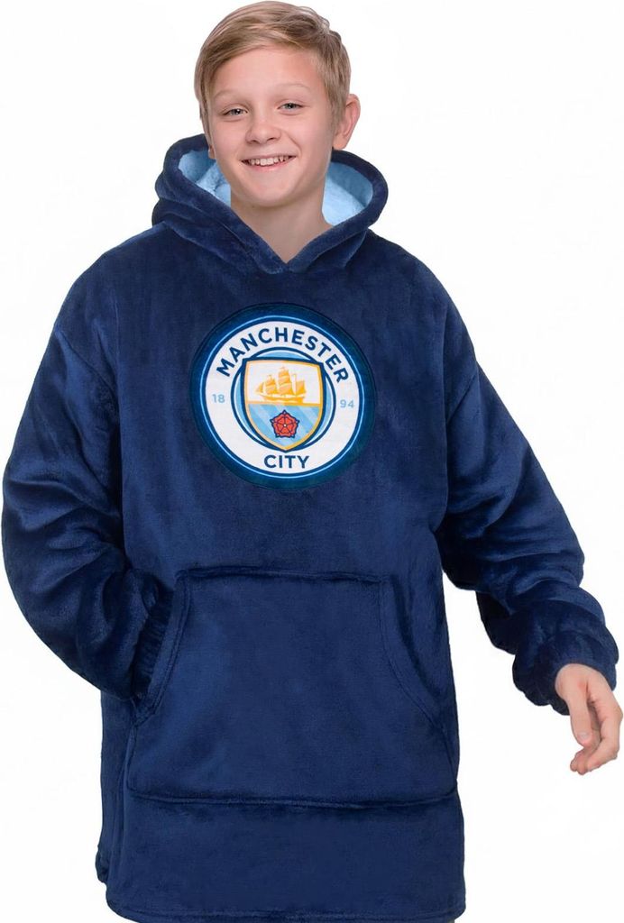 A young boy wearing a dark blue Manchester City FC hoodie.