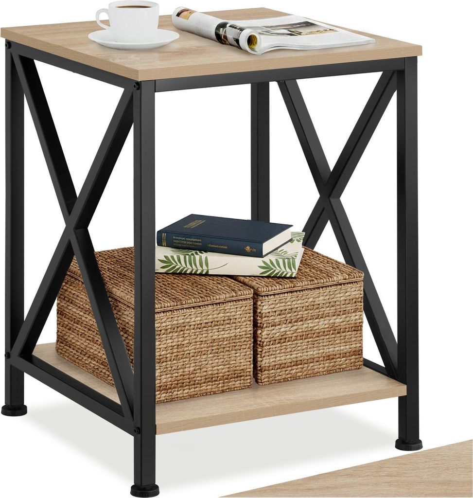 A close-up shot of a wooden and black side table with items on it.