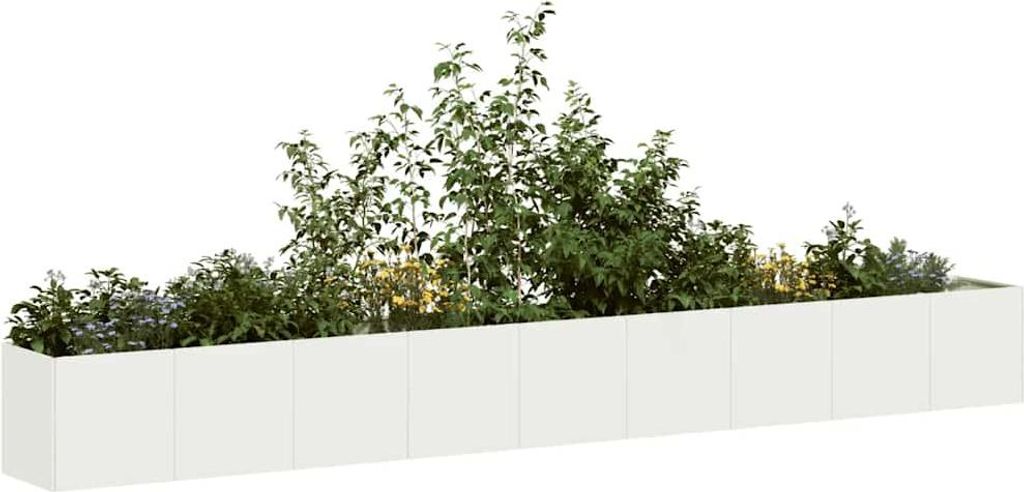 A white planter box filled with various green plants.