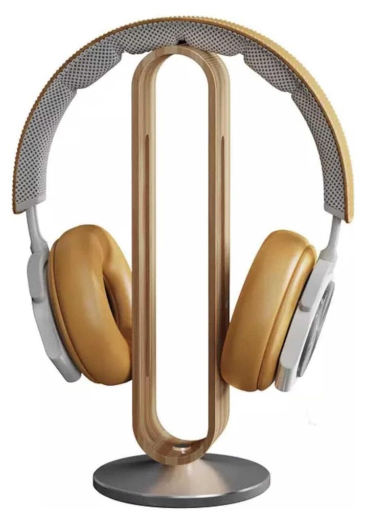 A pair of headphones rests on a wooden stand.