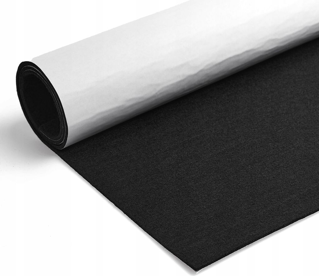 A roll of black felt with a white backing is partially unrolled on a white surface.