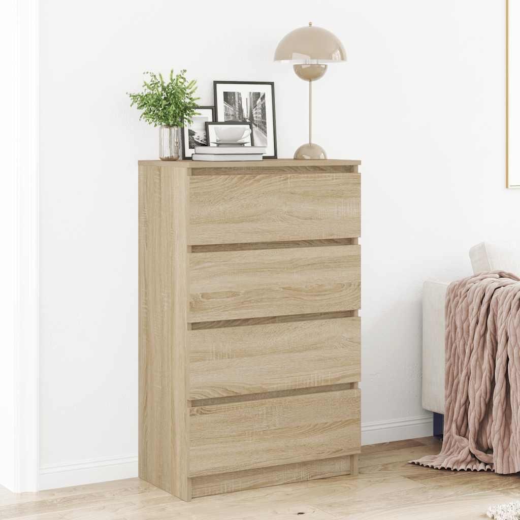 A wooden chest of drawers with decorative items on top, placed against a white wall.