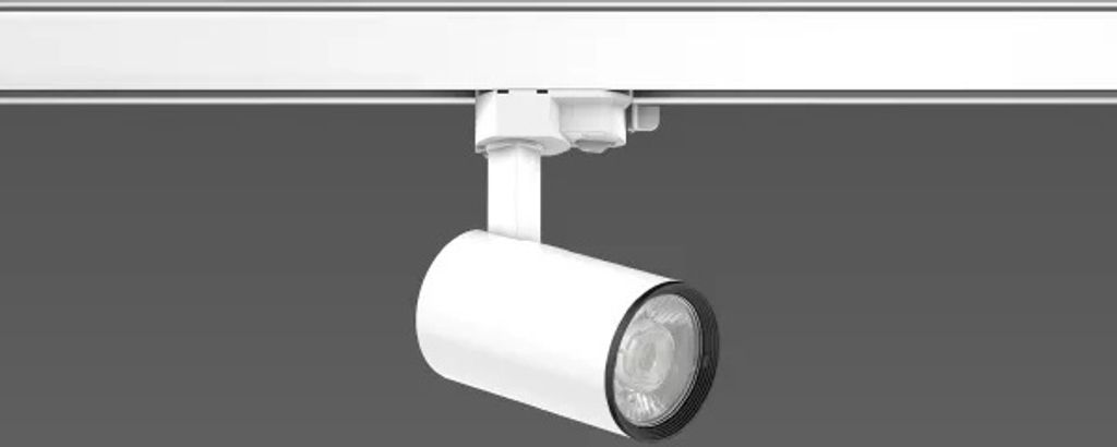A white track light fixture is mounted on a white track against a gray background.