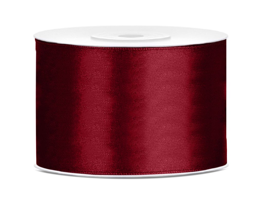 A roll of burgundy satin ribbon on a white spool, presented against a white background.
