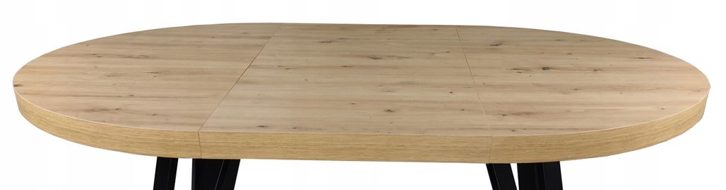 A close-up view of an oval wooden table with black legs.