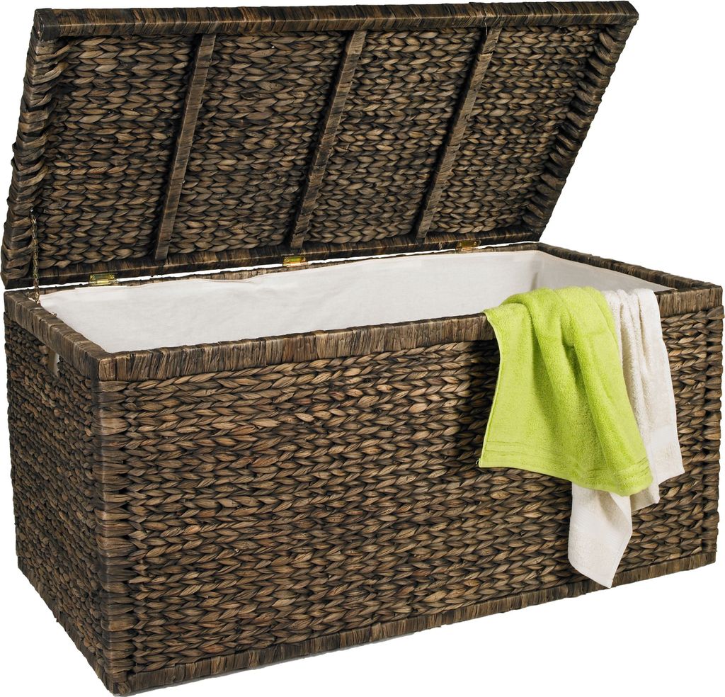 An open woven basket chest with a white liner, containing two folded towels.