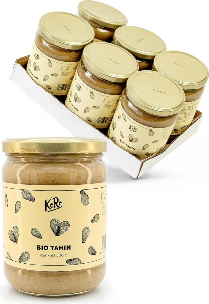 A close-up of a single jar of tahini in the foreground, with a tray of six jars in the background.