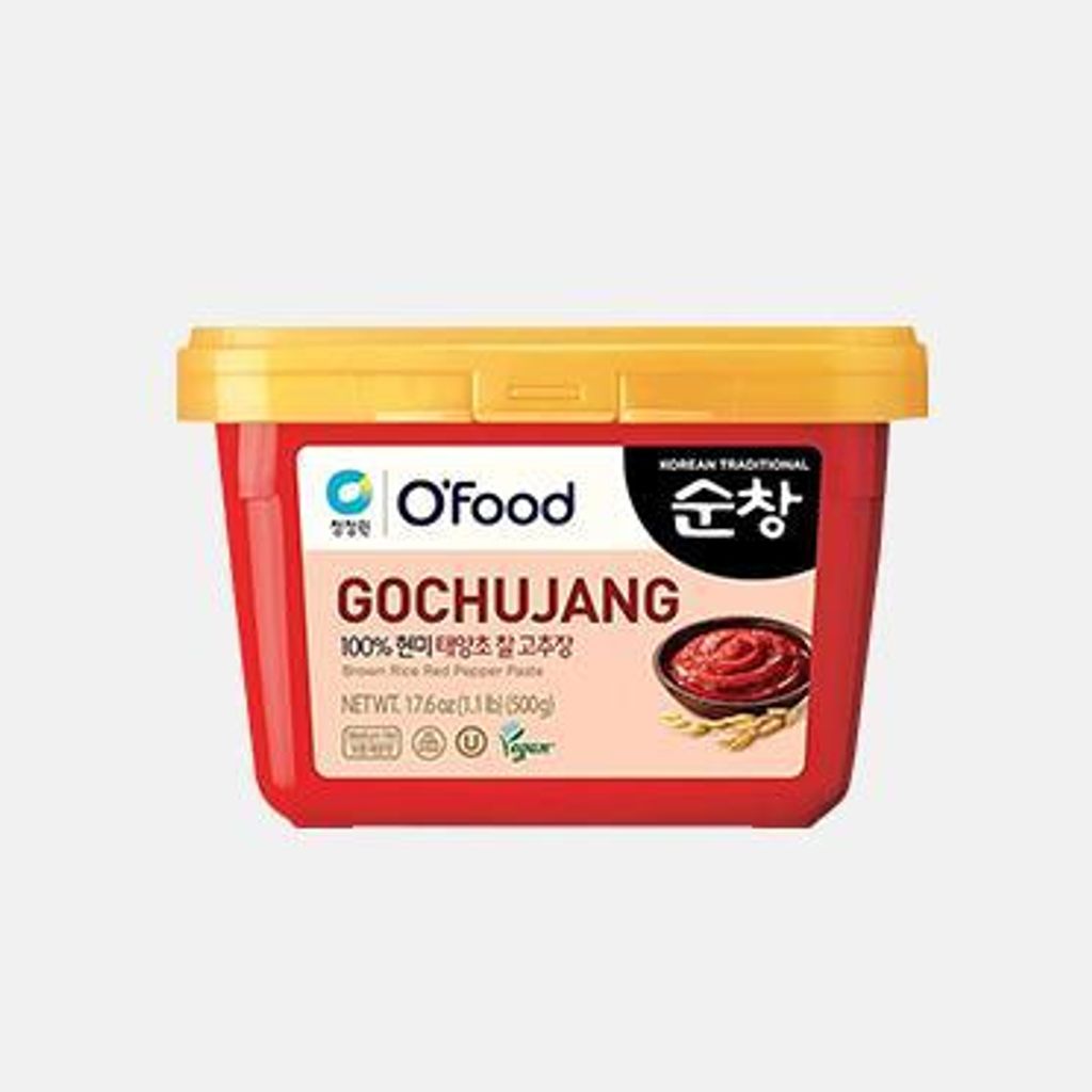 A red tub of Gochujang paste with a yellow lid, against a white background.