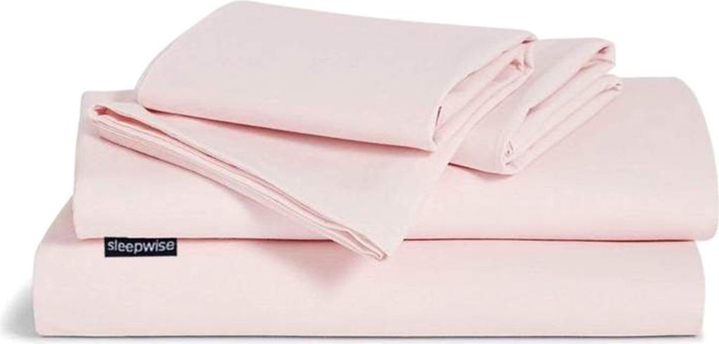 A stack of folded pink bedding.