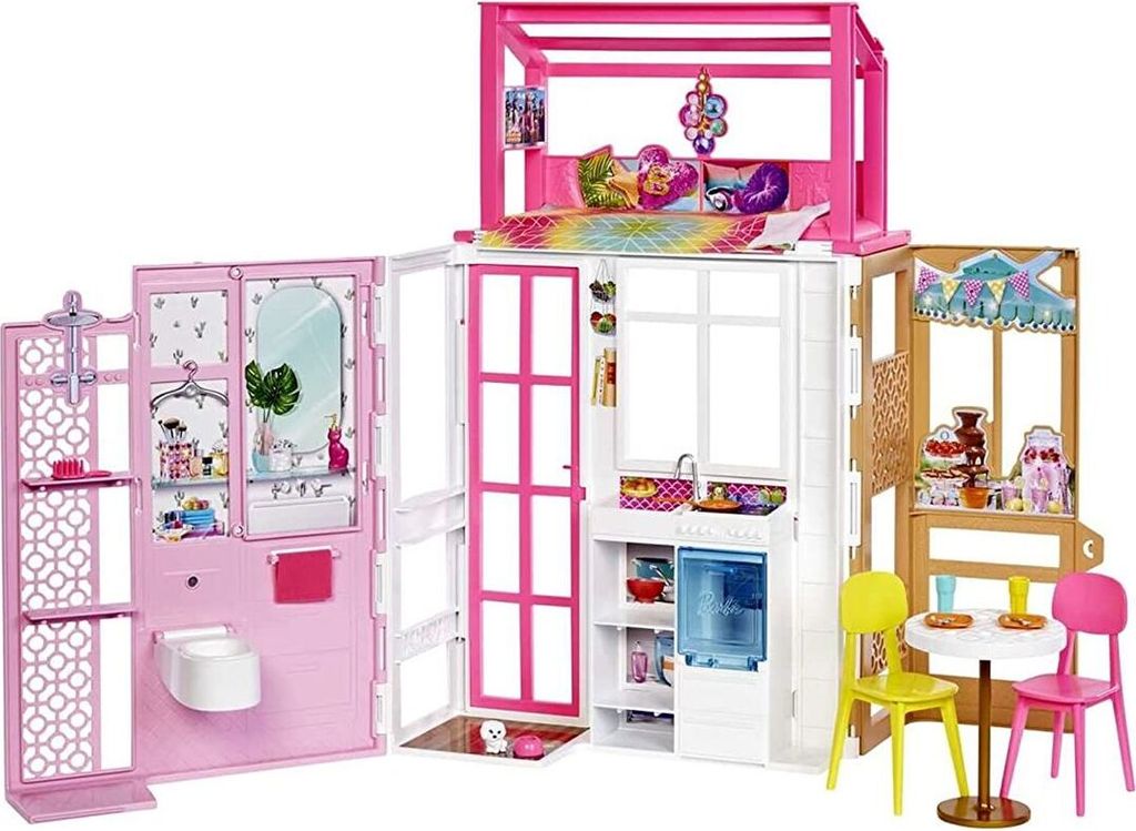 A Barbie dollhouse with multiple rooms and accessories.