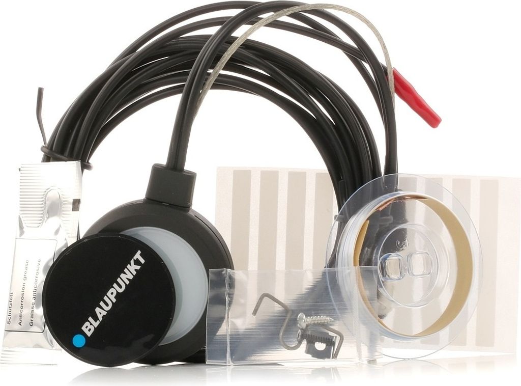 A collection of electronic components and accessories, including cables, a circular device with branding, and other small parts, laid out against a white background.