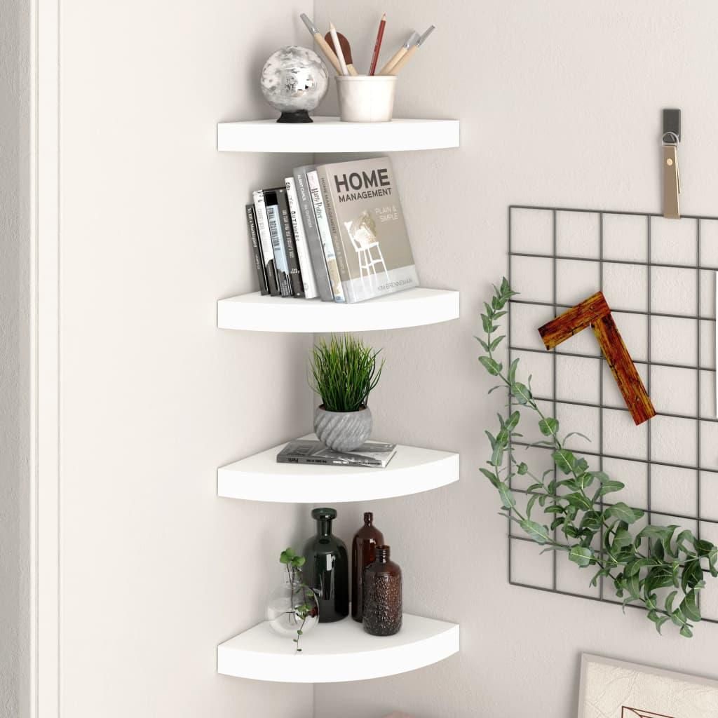 Four white corner shelves are mounted on a light gray wall, displaying various decorative items and books.
