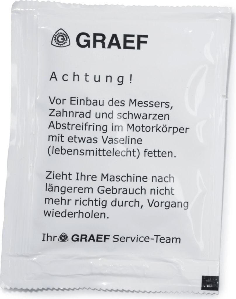 A small white packet with instructions printed on it.