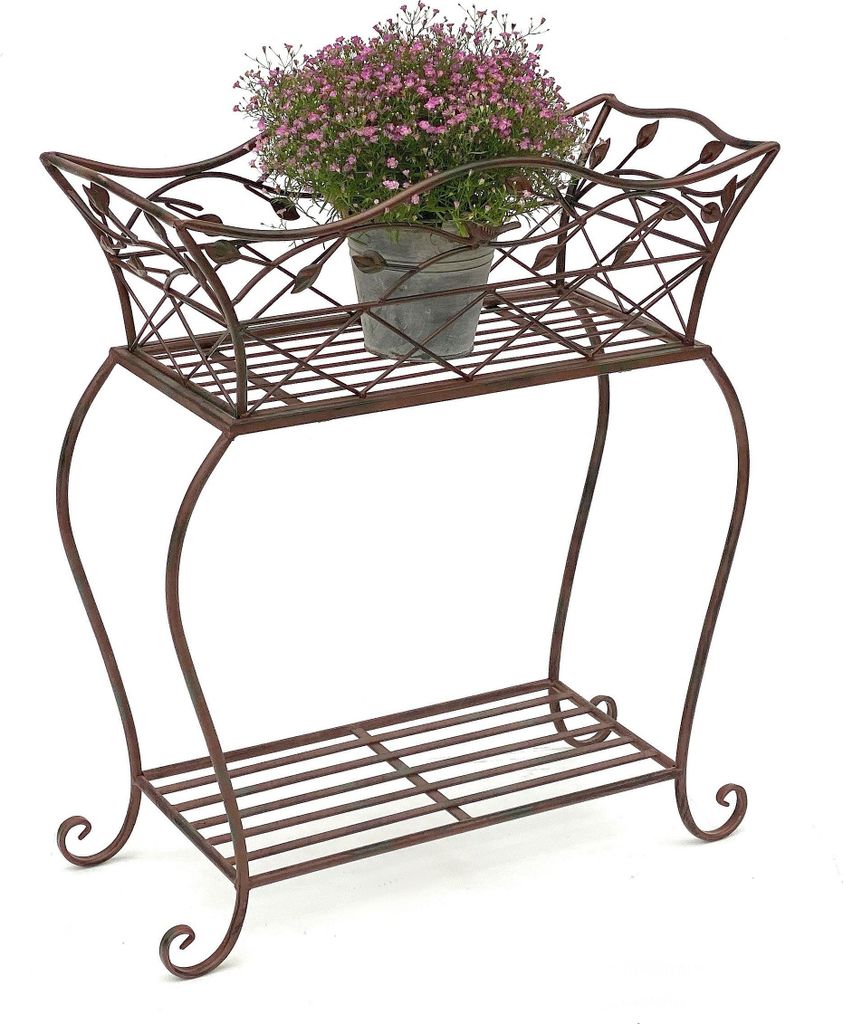 A brown metal plant stand with a potted plant on the top shelf.