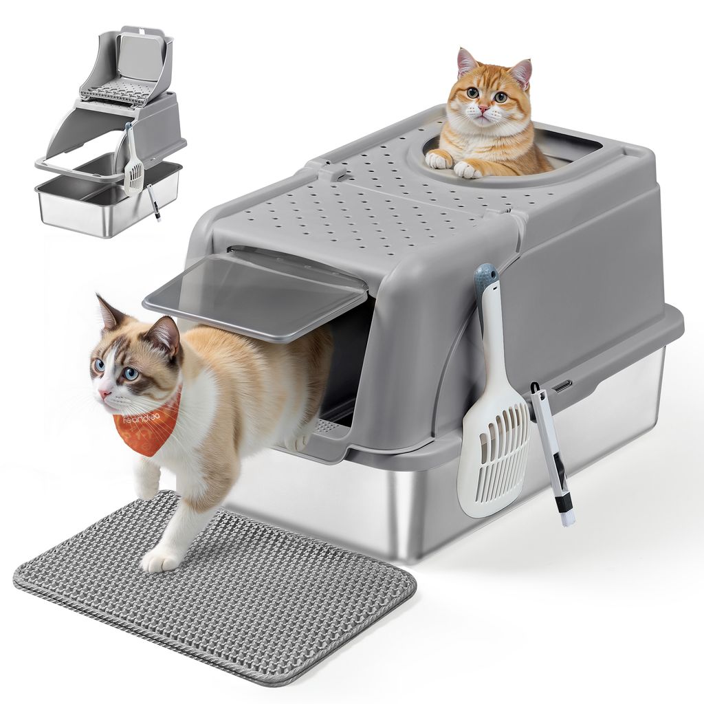 Two cats are interacting with a modern, enclosed litter box with a scoop and brush attached.