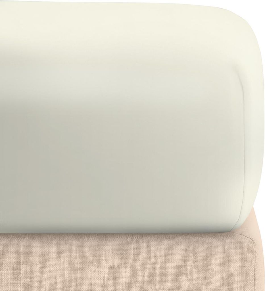 A close-up view of a cream-colored fitted sheet folded over a beige fabric base.