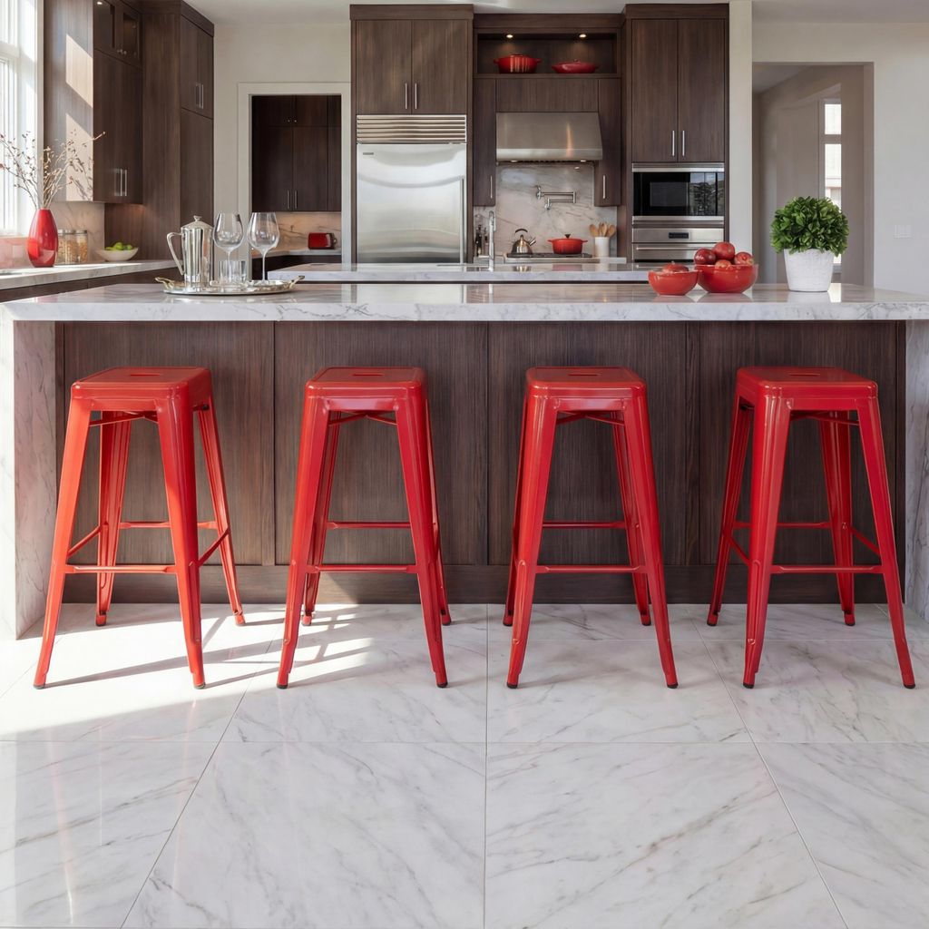 A modern kitchen with dark wood cabinets, a stainless steel refrigerator, and a marble countertop. Four red bar stools are arranged in front of the counter.