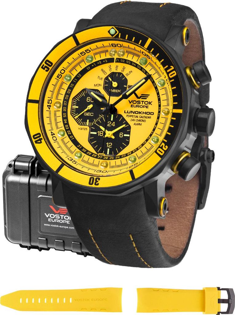 A Vostok Europe watch with a yellow dial and black leather strap, shown with its packaging and an extra yellow strap.