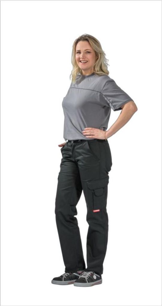 A woman is standing and posing in a studio setting, wearing the product.
