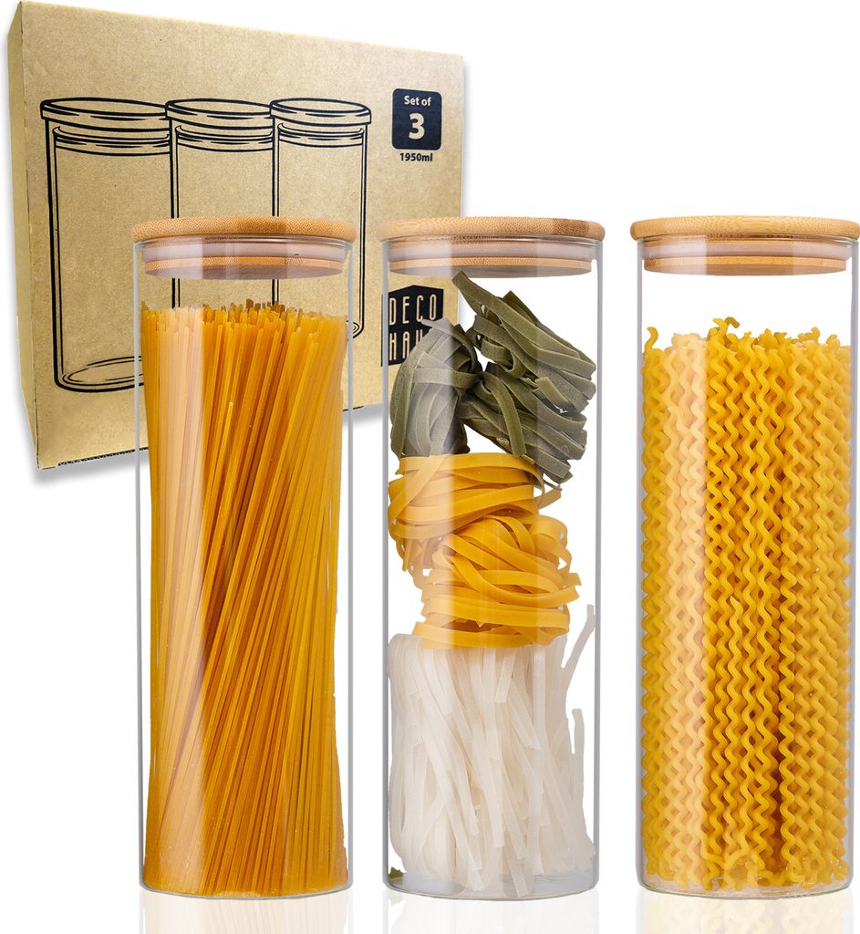 Three glass jars filled with different types of pasta, with a cardboard box in the background.