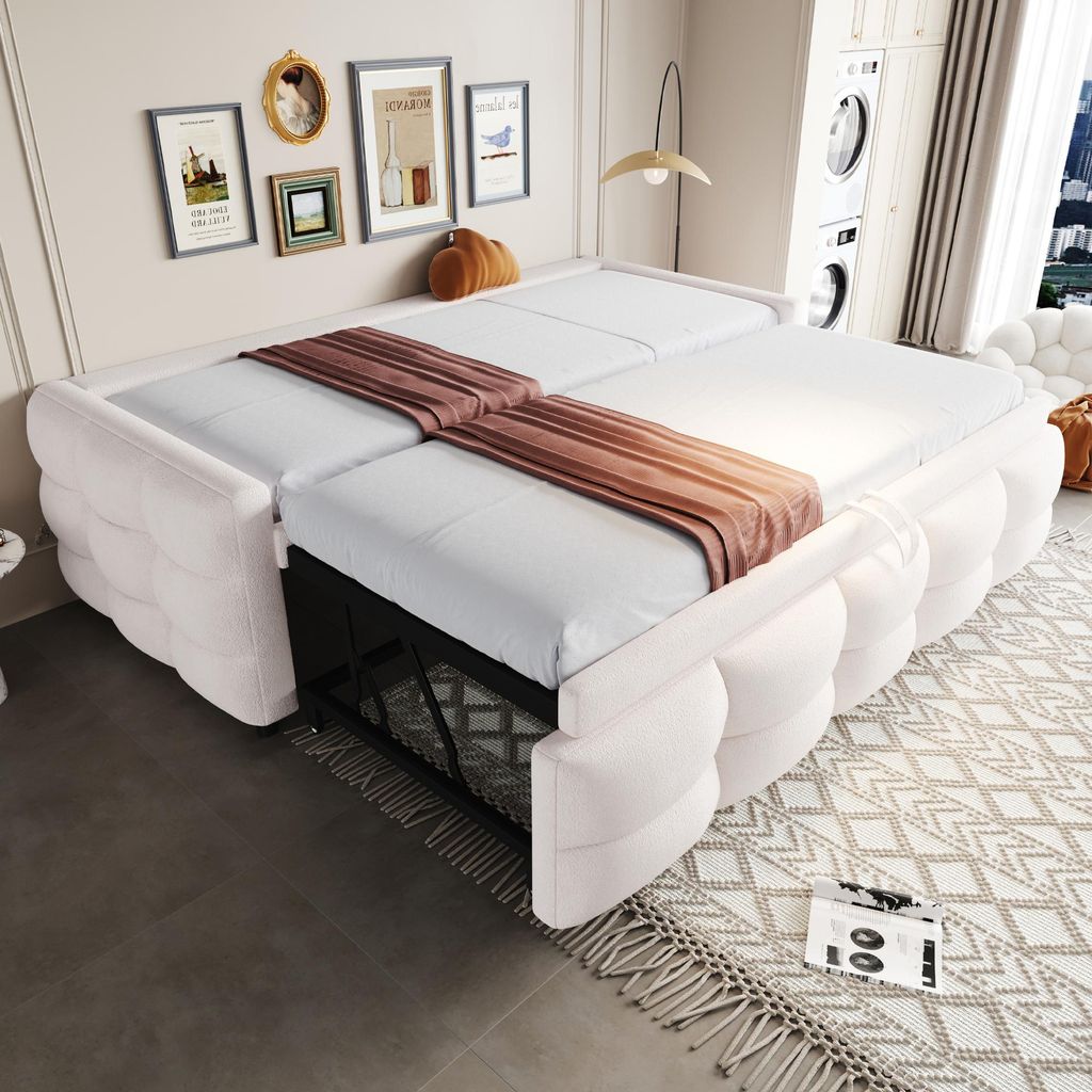 A white sofa bed is shown in a room with framed pictures on the wall and a window in the background.