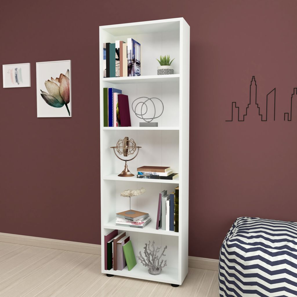 A white bookshelf filled with books and decorative items, placed against a dark brown wall.