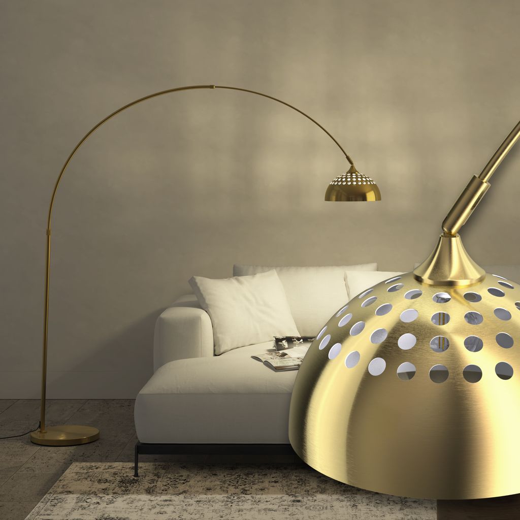 A modern living room with a white sofa and a gold arc floor lamp.
