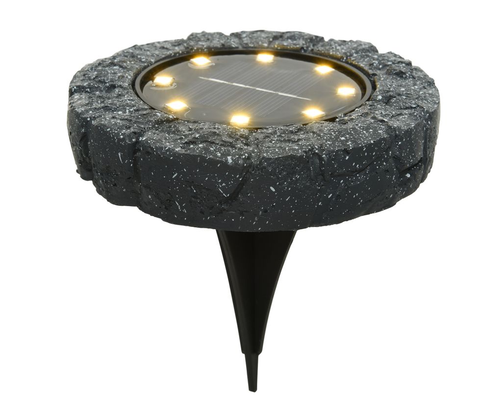 A solar-powered ground light with a stone-like texture.