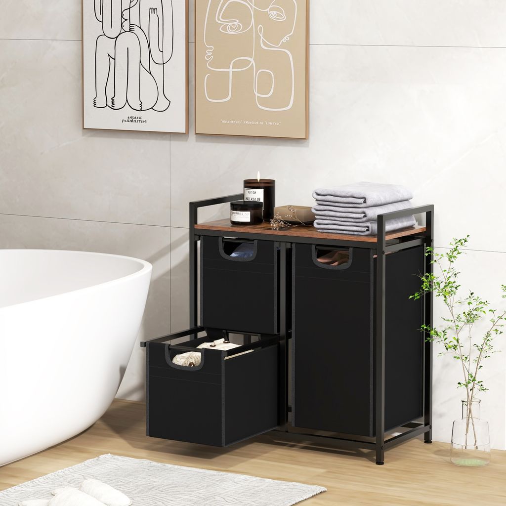 A bathroom scene with a freestanding laundry sorter, bathtub, and artwork on the wall.