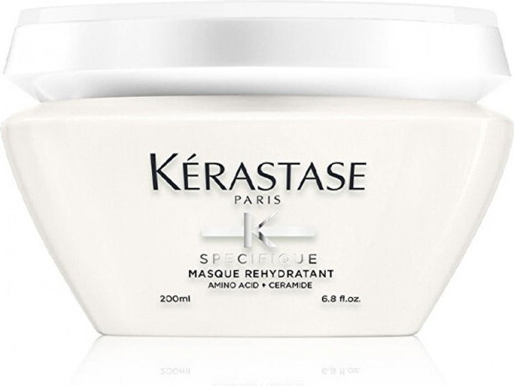 A white jar of Kérastase hair mask is shown against a white background.