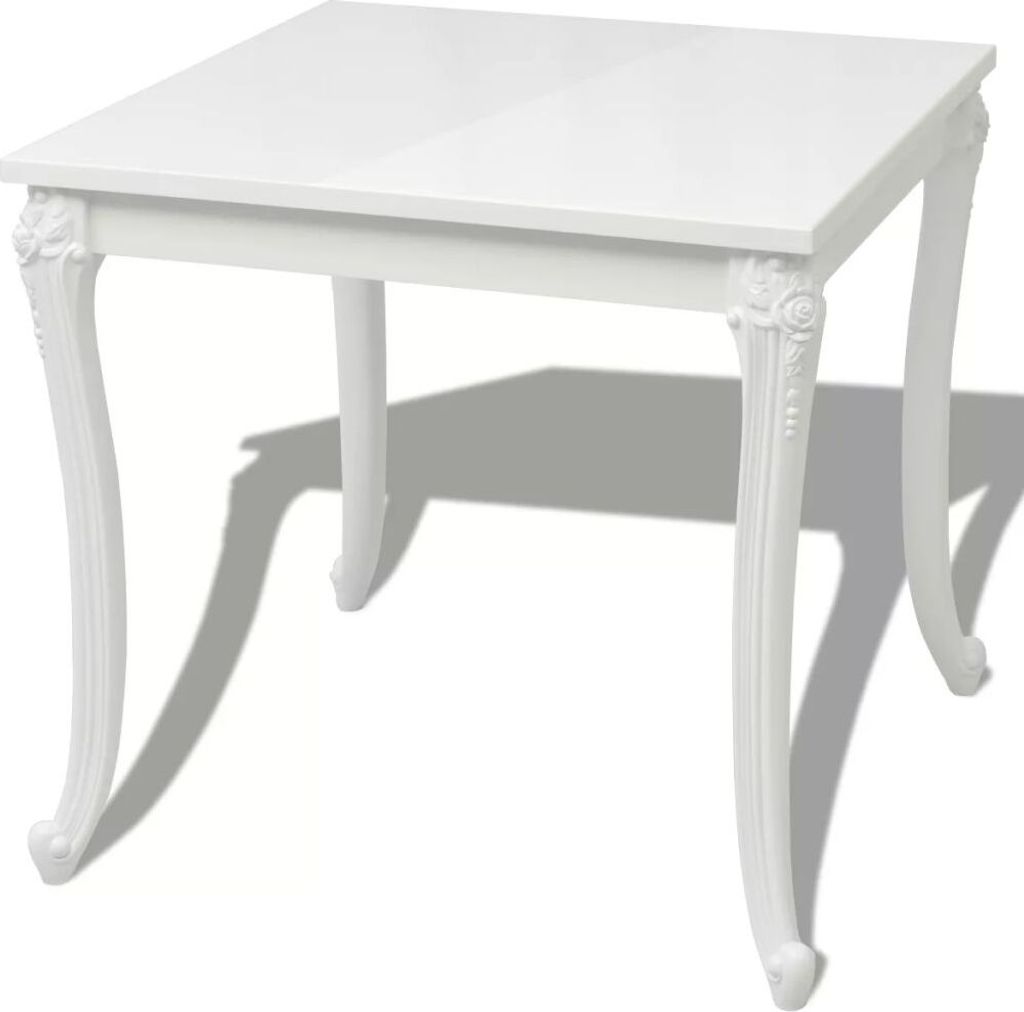 A white square dining table with ornate legs.