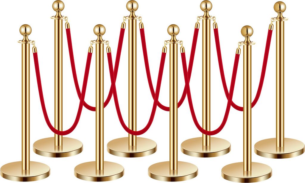 A group of gold stanchions with red ropes.