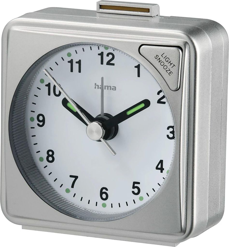 A close-up studio shot of a silver analog alarm clock.
