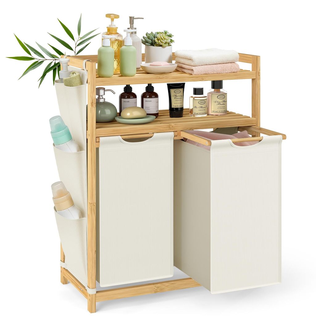 A bamboo laundry hamper with two compartments and shelves, filled with various bathroom products and towels.