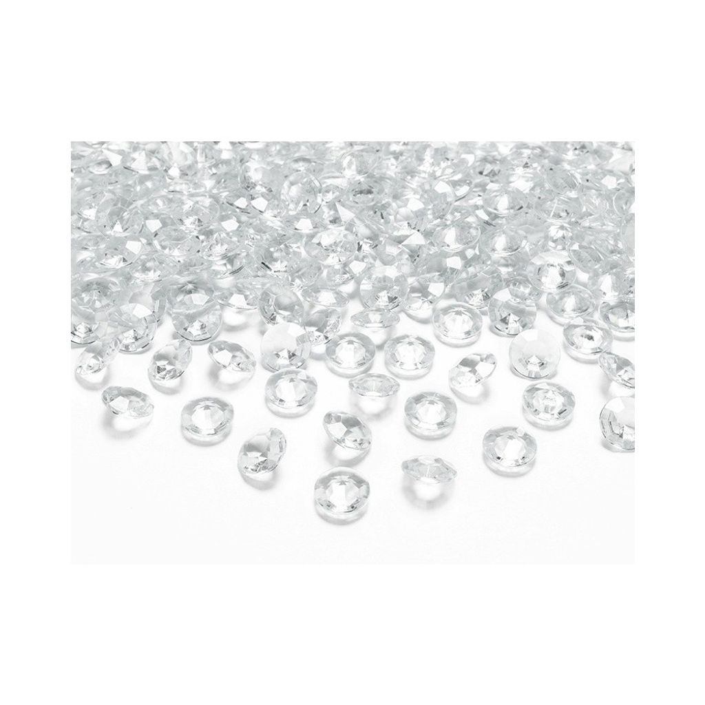 A pile of small, clear, faceted plastic or glass gems scattered on a white surface.