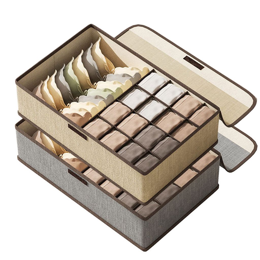 Two fabric storage bins with internal dividers, stacked, and filled with folded garments.
