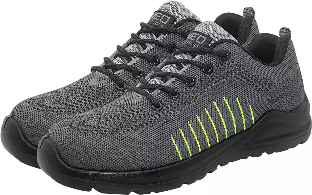 A pair of grey work shoes with black soles and laces, and yellow accents on the side.