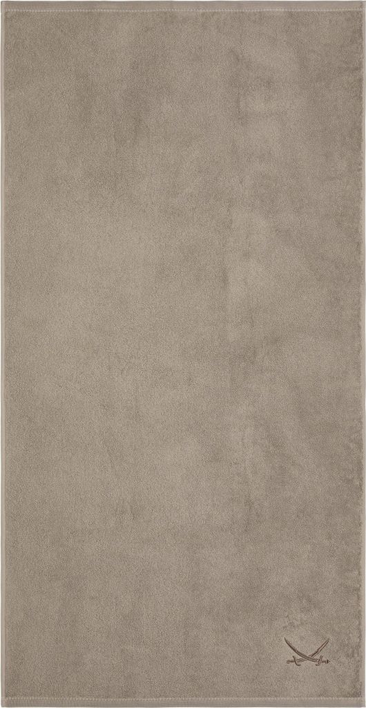A taupe colored towel with a small embroidered logo in the bottom right corner.