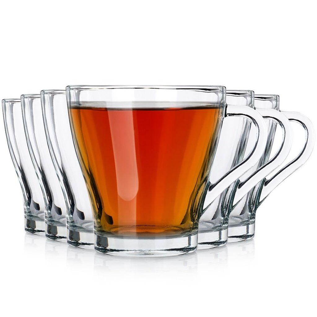 A set of clear glass cups, one filled with tea, arranged in a row against a white background.