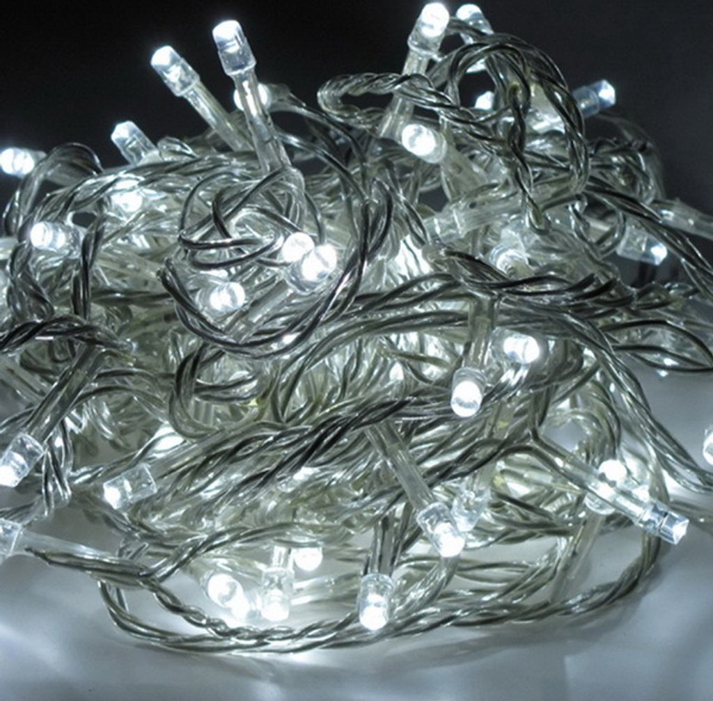 A close-up, tangled pile of white LED string lights with transparent wires.