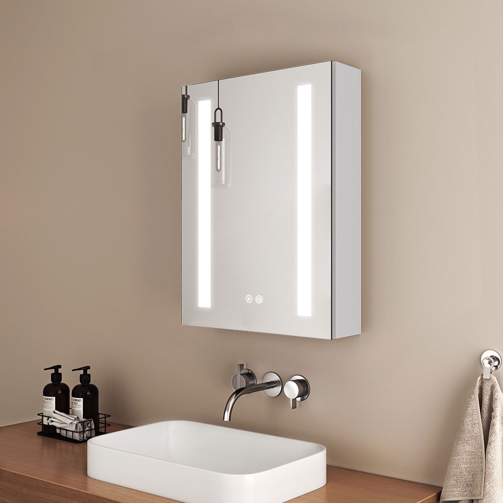 A modern bathroom sink and illuminated medicine cabinet.