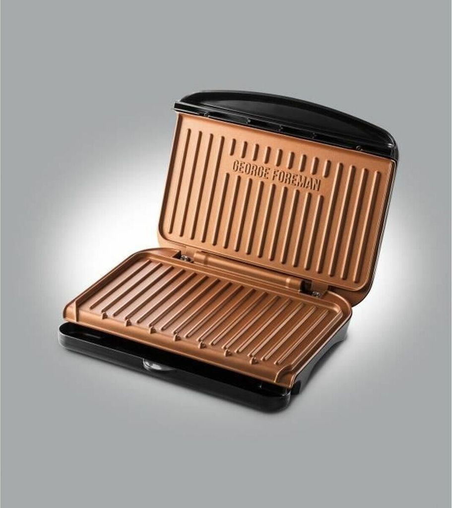 An open George Foreman grill with a copper-colored interior.