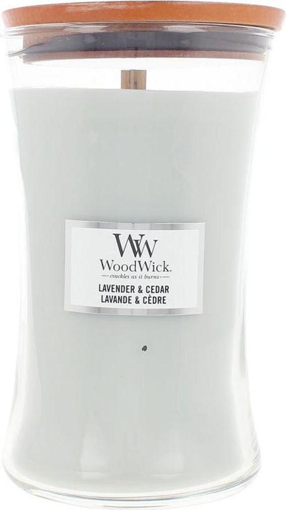 A large glass candle with a wooden lid and a light gray wax.