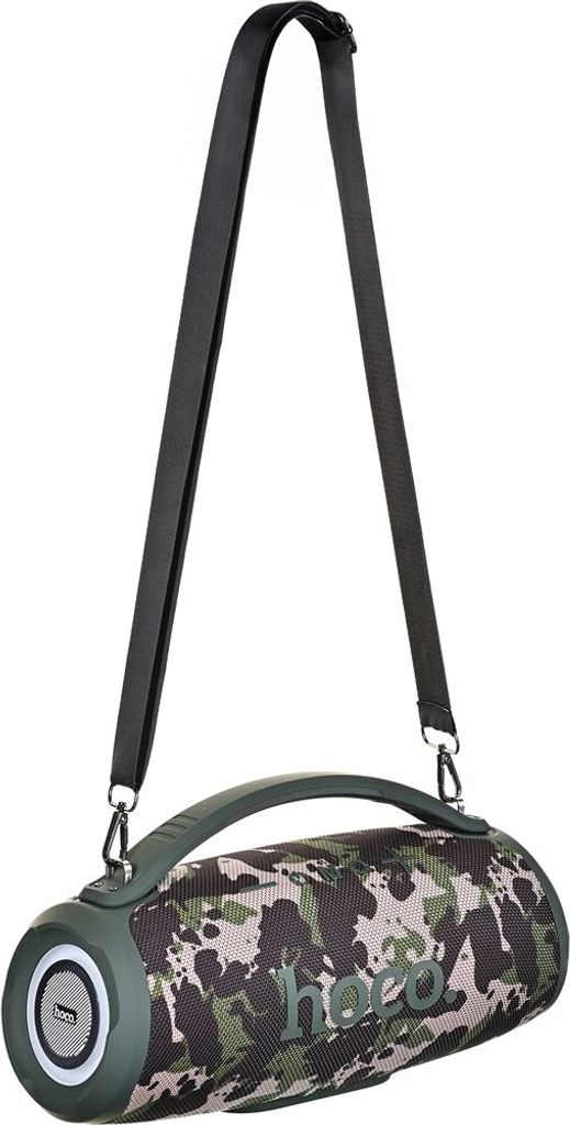 A portable speaker with a camouflage pattern and a carrying strap.