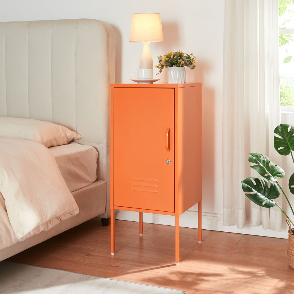 A bedside table next to a bed in a bedroom.