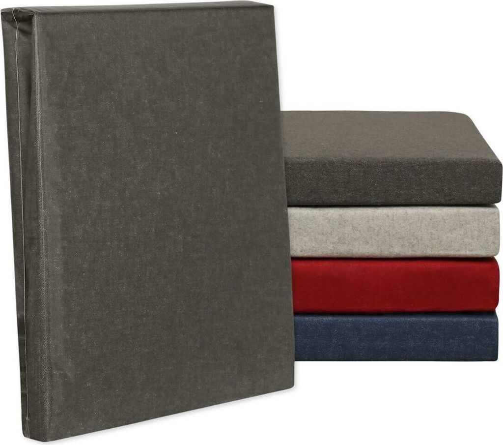 A stack of fitted sheets in different colors, with one sheet standing upright in the foreground.