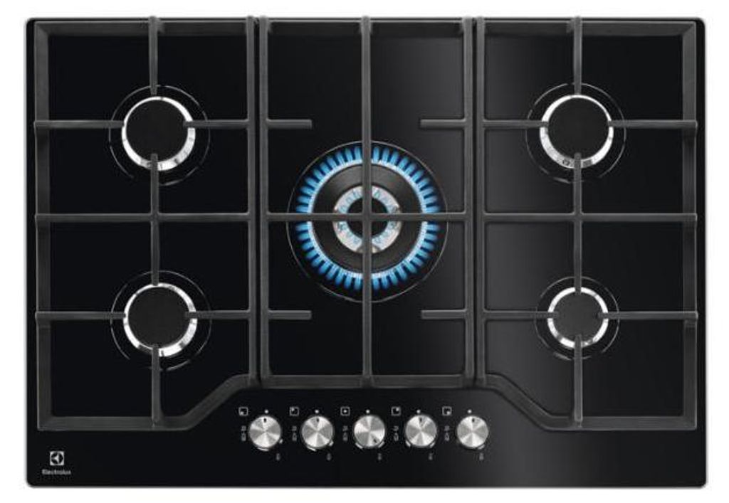 A top-down view of a black gas stovetop with five burners, one of which is lit with a blue flame.