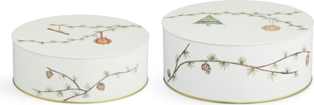 Two round decorative tins with a Christmas-themed pine branch and pine cone design.