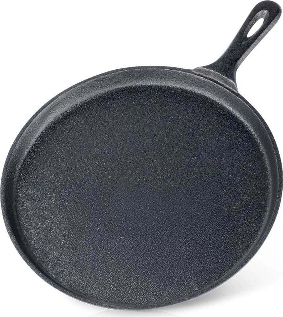 A black cast iron crepe pan shown from a diagonal angle, with the handle pointing towards the top right.
